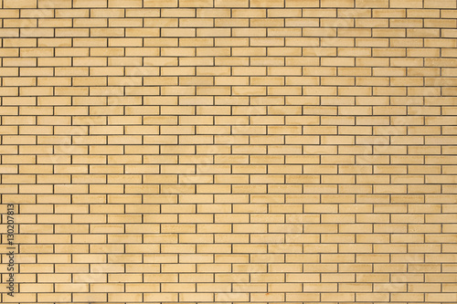 High resolution texture of a yellow brick wall. Laying horizonta