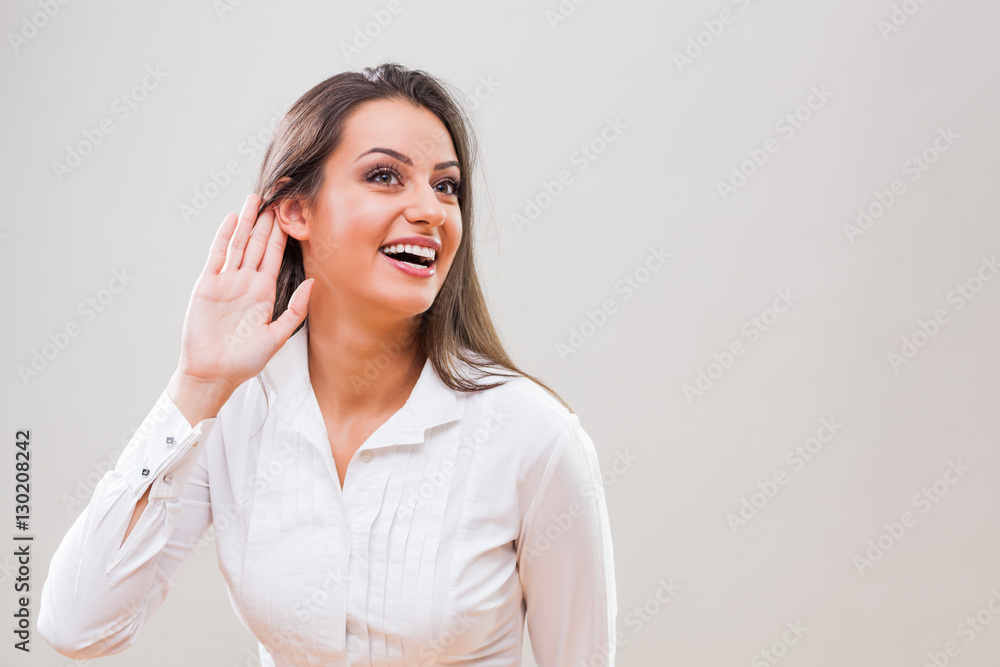 Portrait of young businesswoman who is trying to hear something . Portrait of young businesswoman who is trying to hear something .