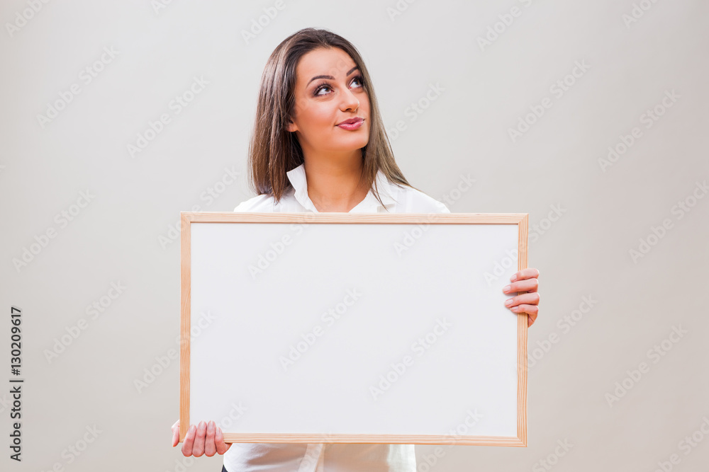 Portrait of businesswoman who is holding white table with blank space for your advertisement. Portrait of businesswoman who is holding white table with blank space for your advertisement.