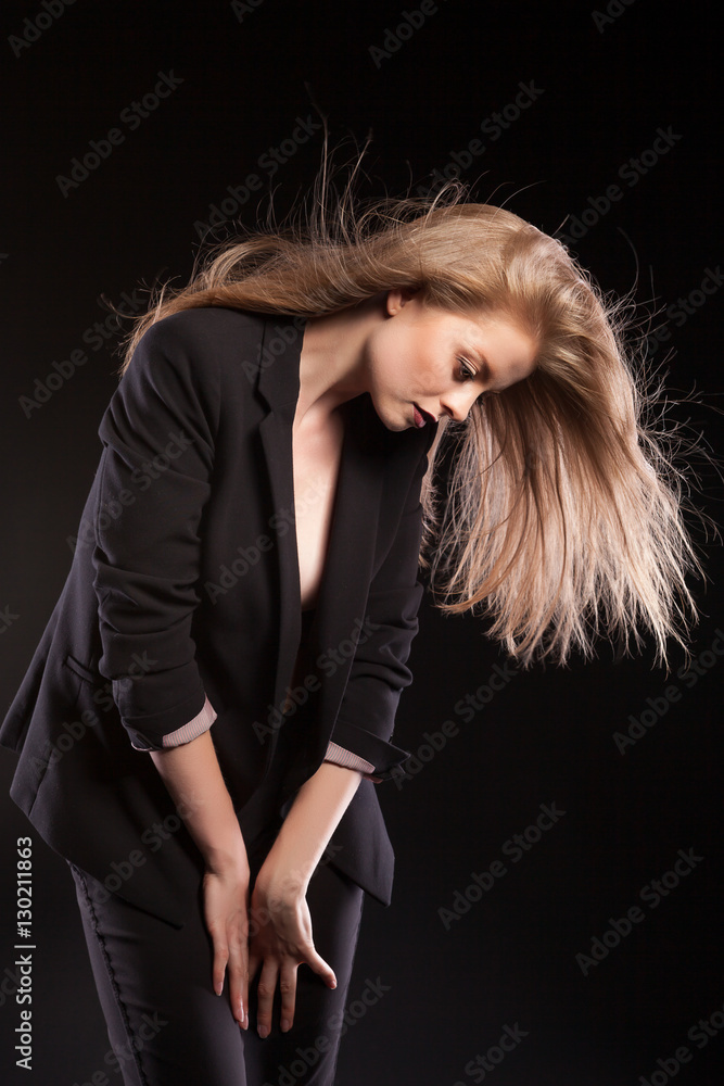Sexy woman in fashion suite blowing her hairs in the air Sexy woman in fashion suite blowing her hairs in the air