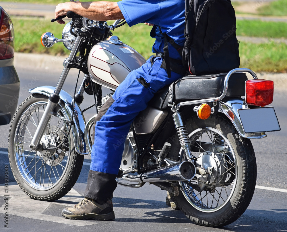 Man with a motorcycle on the street Man with a motorcycle on the street
