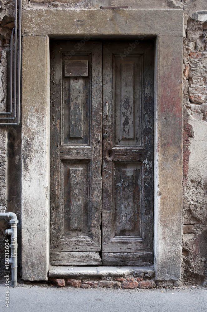 old wooden door in italian city Brescia