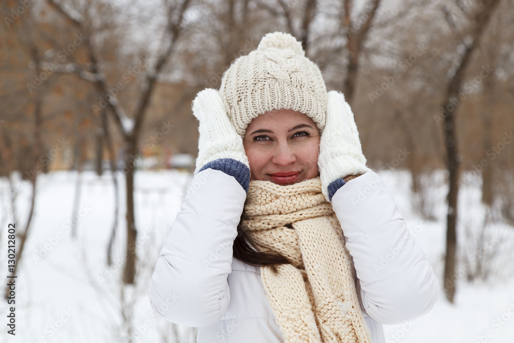 Fototapeta premium The girl in a winter white down-padded coat