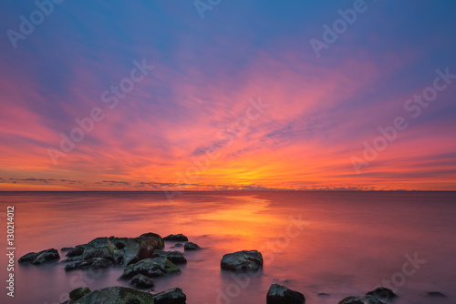 Fototapeta Naklejka Na Ścianę i Meble -  Vibrant Sunrise Seascape from a Jetty 