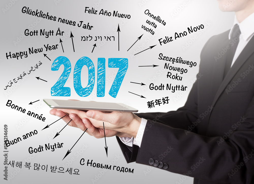 2017 Happy New Year, young man holding a tablet computer 2017 Happy New Year, young man holding a tablet computer