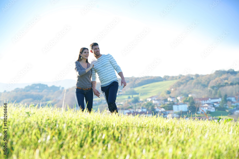 Couple walking in countryside on sunny fall day Couple walking in countryside on sunny fall day