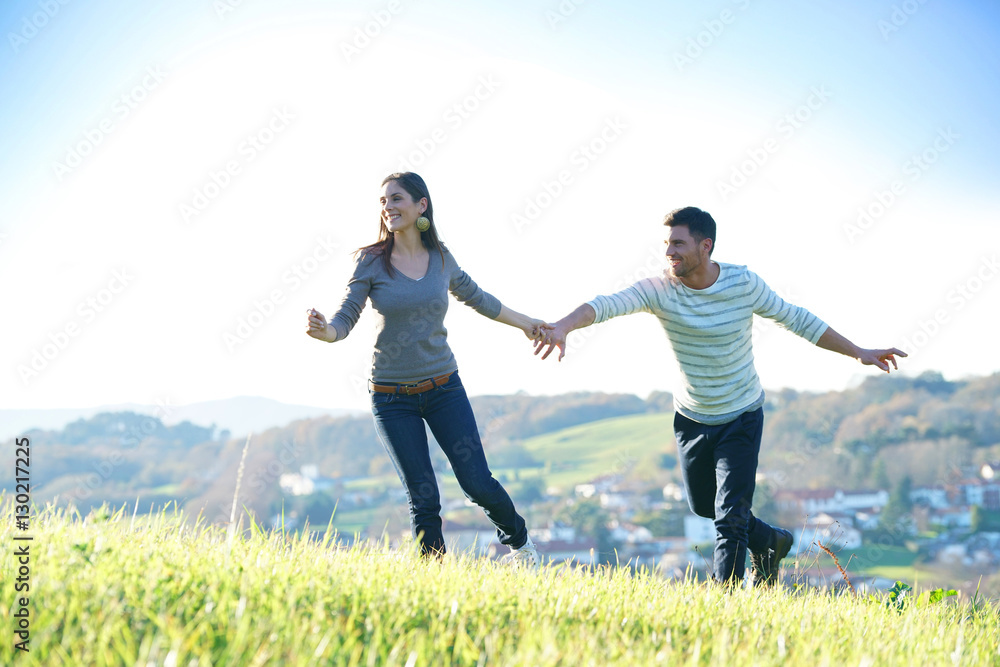 Couple walking in countryside on sunny fall day Couple walking in countryside on sunny fall day