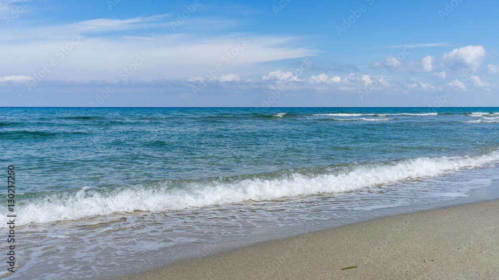 View on Mediterranean Sea with sunny sand beach. Nei Pori village, Pieria, Greece.
