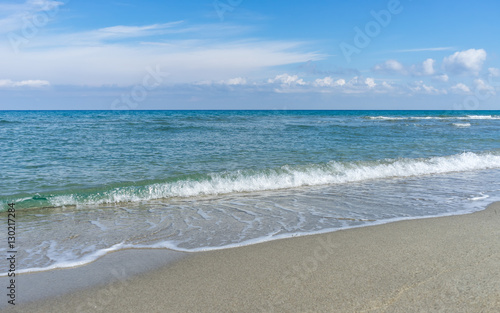 View on Mediterranean Sea with sunny sand beach. Nei Pori village, Pieria, Greece. 