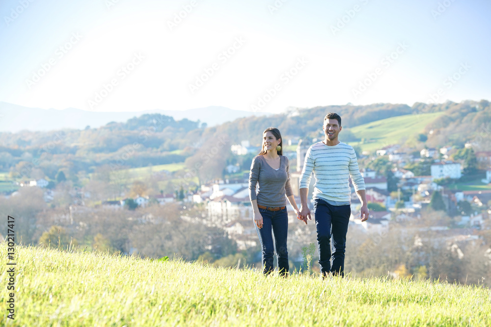 Couple walking in countryside on sunny fall day Couple walking in countryside on sunny fall day