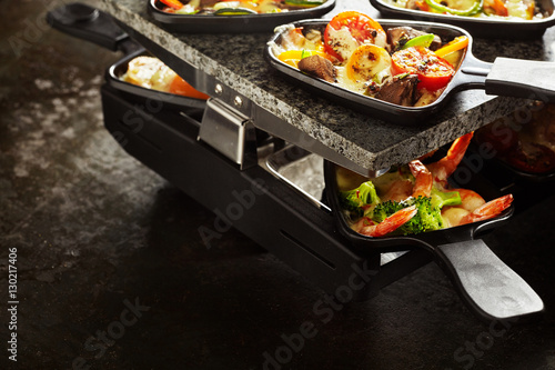 Canvas Print Scrumptious raclette with veggies and seafood