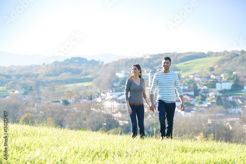 Couple walking in countryside on sunny fall day © goodluz