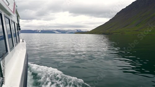 Boat sailing to remote Horstrandir National Park, Iceland. Footage of traveling by small boat in North Iceland. photo