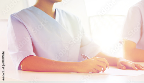 close up of doctor taking notes at hospital