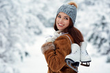 beautiful young woman with ice skates to go to the rink