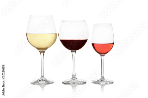 Three glasses with tasty wine on white background