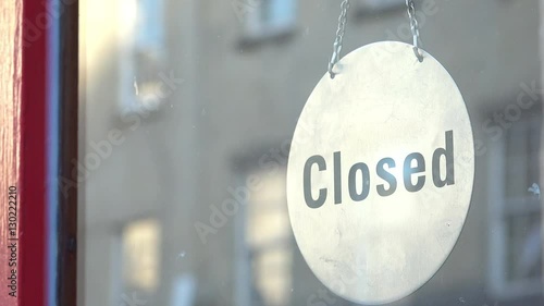 CLOSED sign hanging on the door of a shop photo