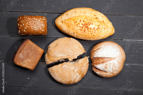 Homemade bread on a black wooden background