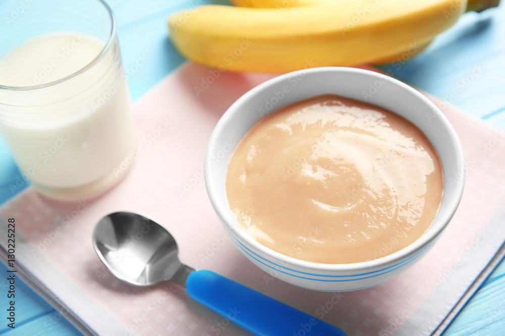 Bowl with healthy baby food on table. Child feeding concept Bowl with healthy baby food on table. Child feeding concept