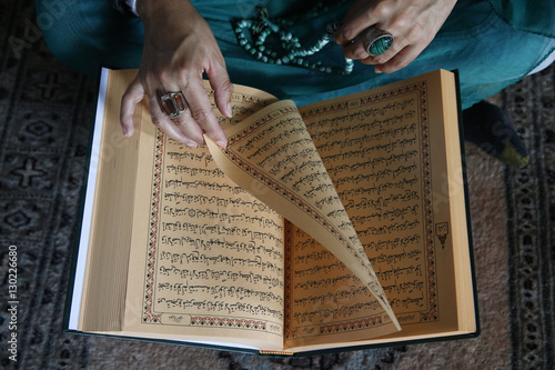Muslim woman reading Kuran, Montrouge, Hauts-de-Seine, France photo