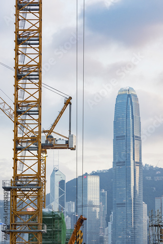 Crnae in construction site with skyscraper background