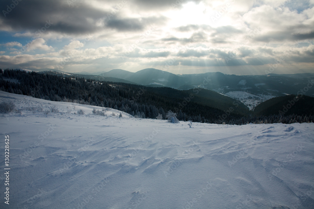 Winter landscape of mountains in rays of the setting sun Winter landscape of mountains in rays of the setting sun