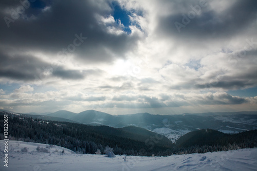 Winter landscape of mountains in rays of the setting sun © okostia