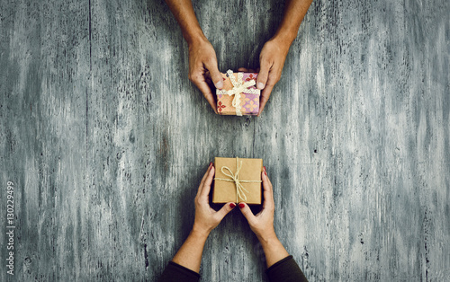 woman and man exchanging gifts photo