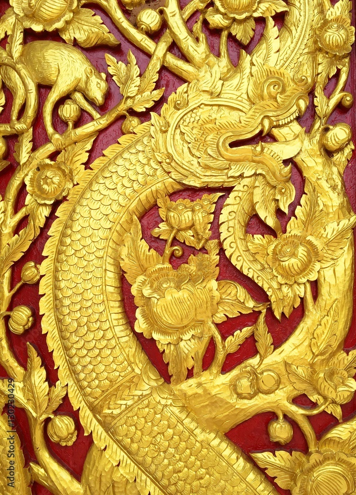 Carved big serpent motifs and tree pattern in the literature. At wall of wooden doors Carved big serpent motifs and tree pattern in the literature. At wall of wooden doors