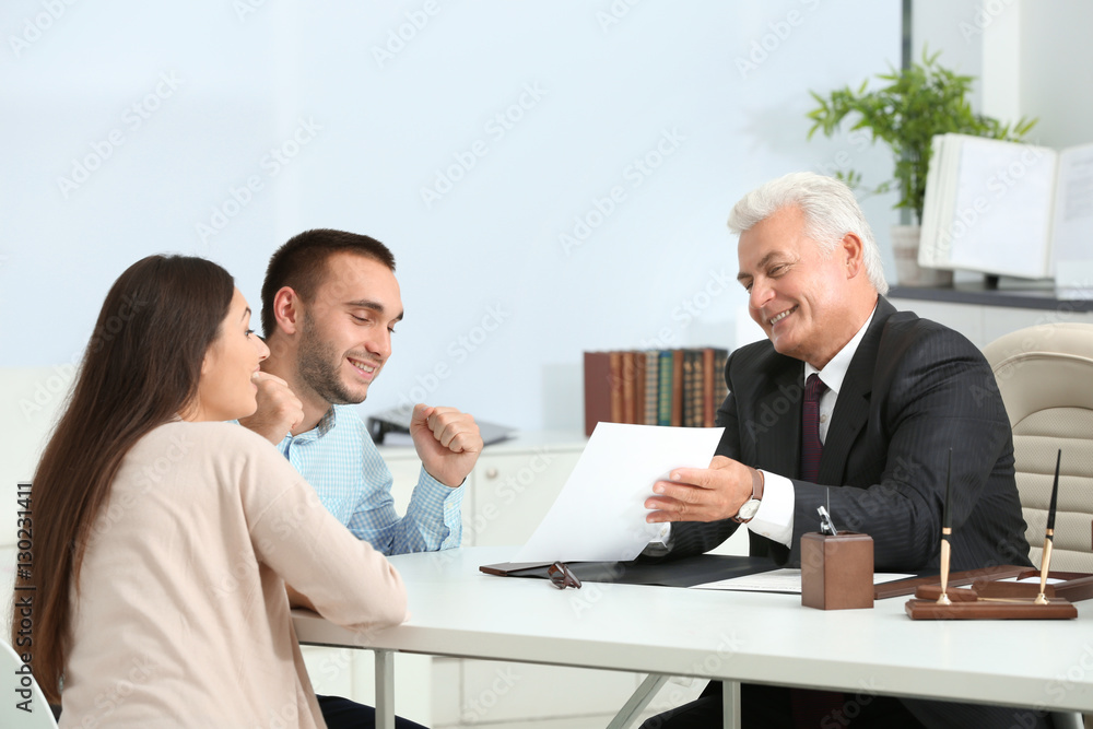 Young couple with notary at office Young couple with notary at office