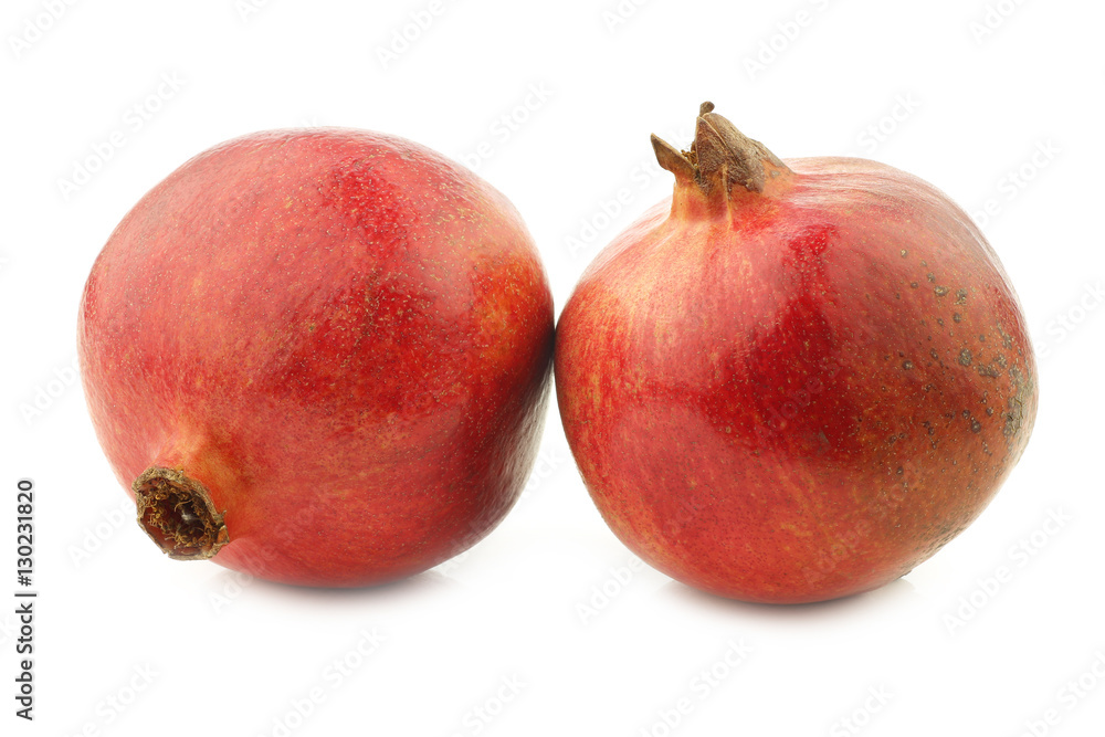 two pomegranate(Punica granatum) on a white background two pomegranate(Punica granatum) on a white background