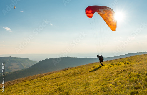 Paraglider in sunny day flying in Palava, hill Devin, South Moravia, Czech Republic