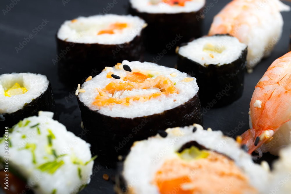 Japanese sushi on black kitchen slate plate. Japanese sushi on black kitchen slate plate.