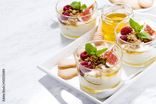 sweet greek yogurt with honey and fresh figs on white table