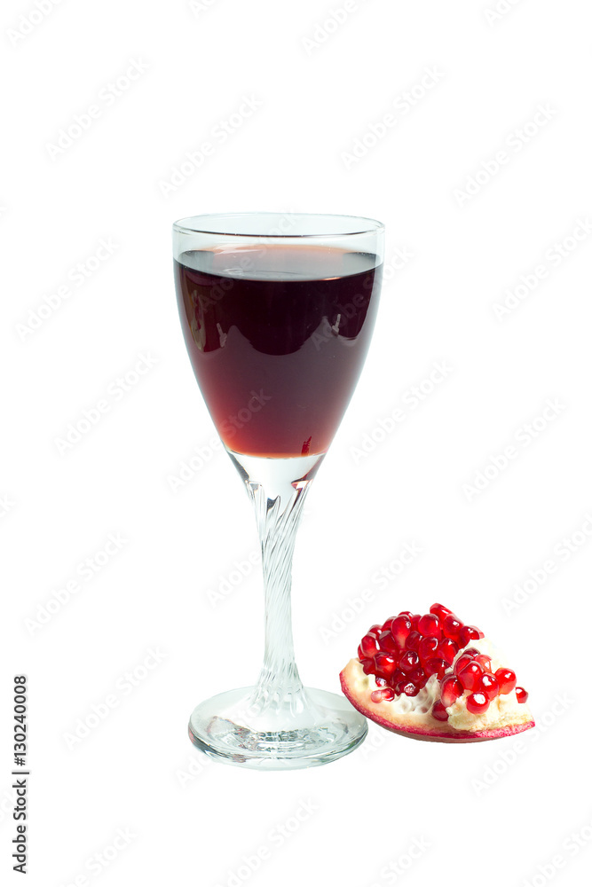 Pomegranate juice in a wine glass and ripe pomegranate Pomegranate juice in a wine glass and ripe pomegranate
