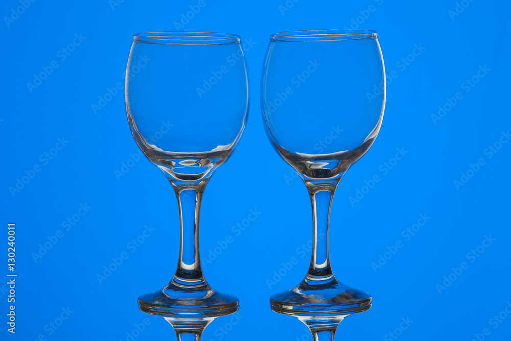 Two wine glasses on blue background Two wine glasses on blue background