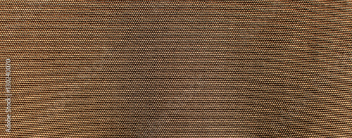 the textured background or wallpaper of rough cotton fabric of khaki color