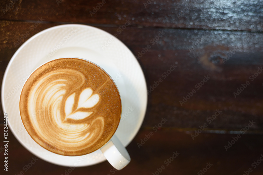 Hot cappuccino on a wooden table in a coffee shop. Hot cappuccino on a wooden table in a coffee shop.