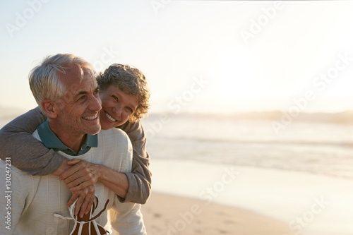 Senior couple having fun at the beach photo