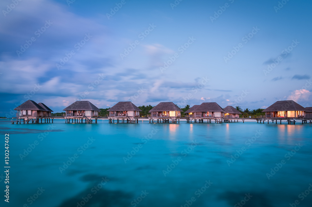 Maldivian water bungalows at dusk