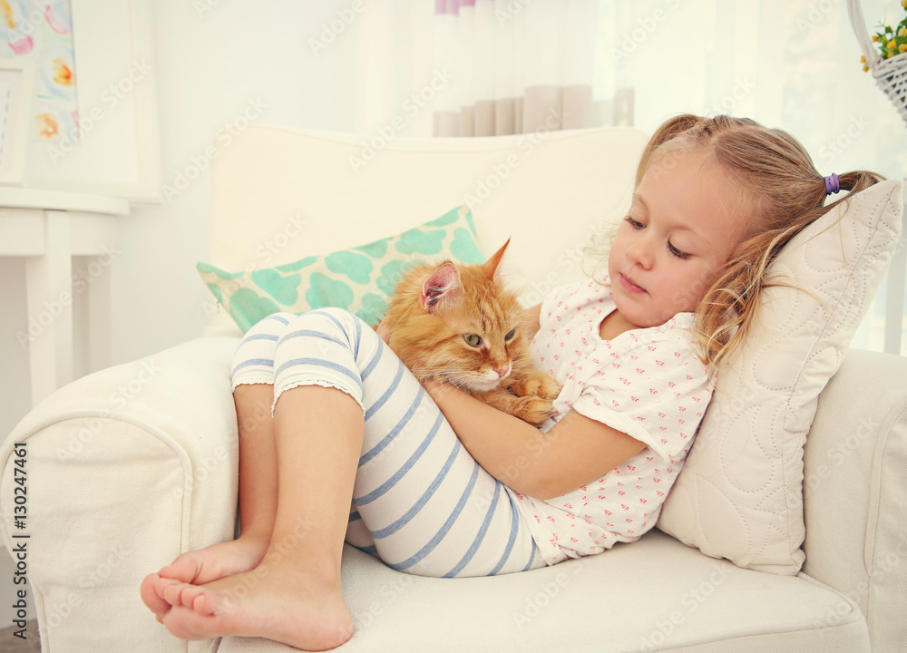 Cute little girl with red cat at home Cute little girl with red cat at home