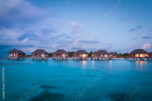 Maldivian water bungalows at dusk