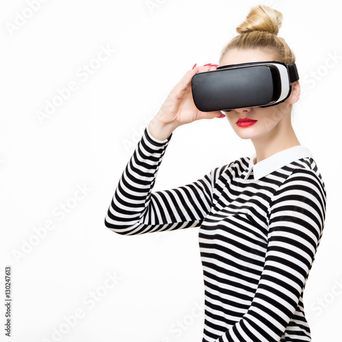 Attractive woman wearing virtual reality glasses. VR headset. Virtual reality concept on white background.