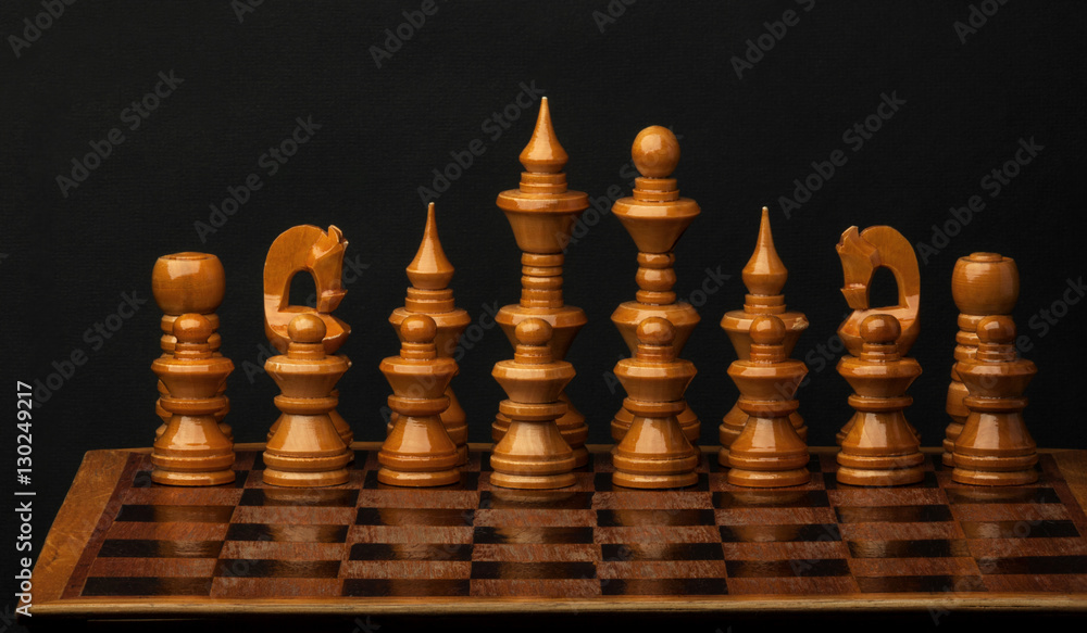 White chess figures on wood board. Set of chess figures. White chess figures on wood board. Set of chess figures.