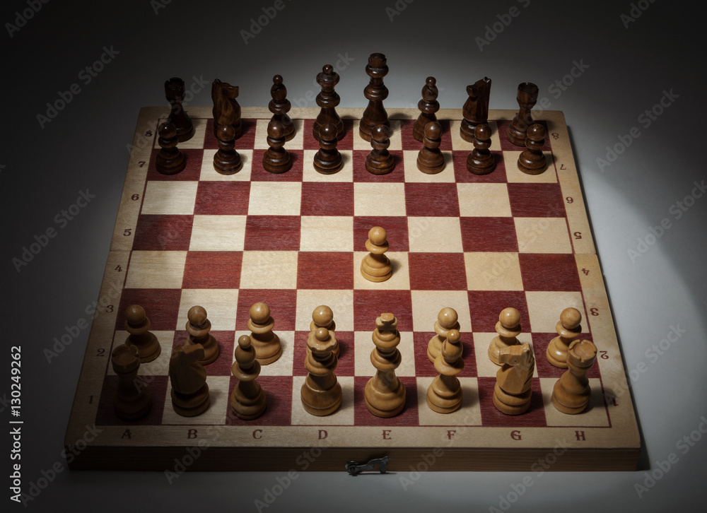 Classic Opening of Chess Game on Wooden Board. First Move, e2-e4. Classic Opening of Chess Game on Wooden Board. First Move, e2-e4.