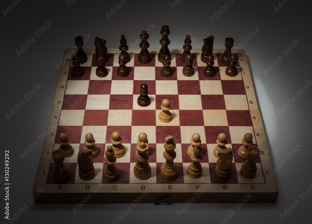 Classic Opening of Chess Game on Wooden Board. First Move, e2-e4. Classic Opening of Chess Game on Wooden Board. First Move, e2-e4.