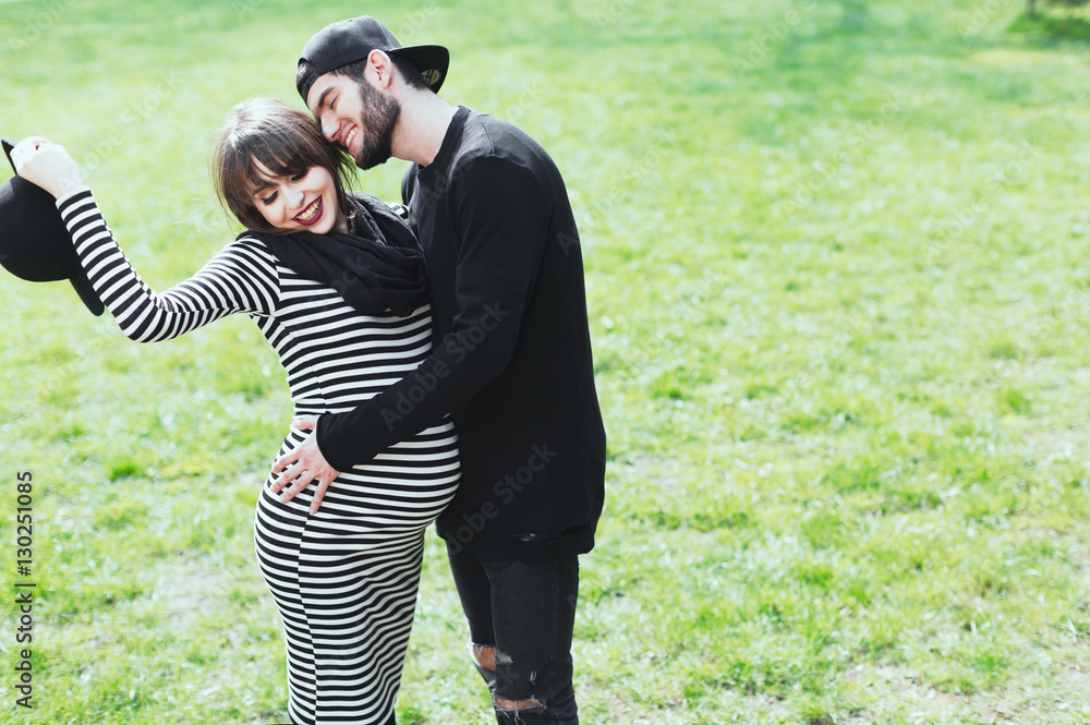 Pregnant woman and man in park Stock Photo | Adobe Stock