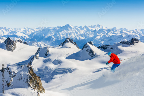 Skier skiing downhill Valle Blanche in french Alps in fresh powd photo