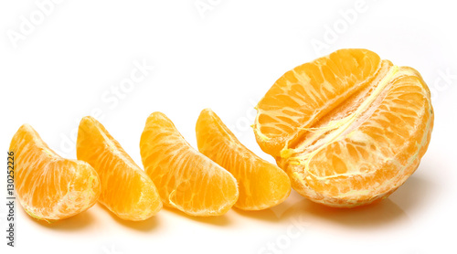 Mandarin  tangerine citrus fruit isolated on white background. Pile of a fresh oranges and several segment of peeled citrus.