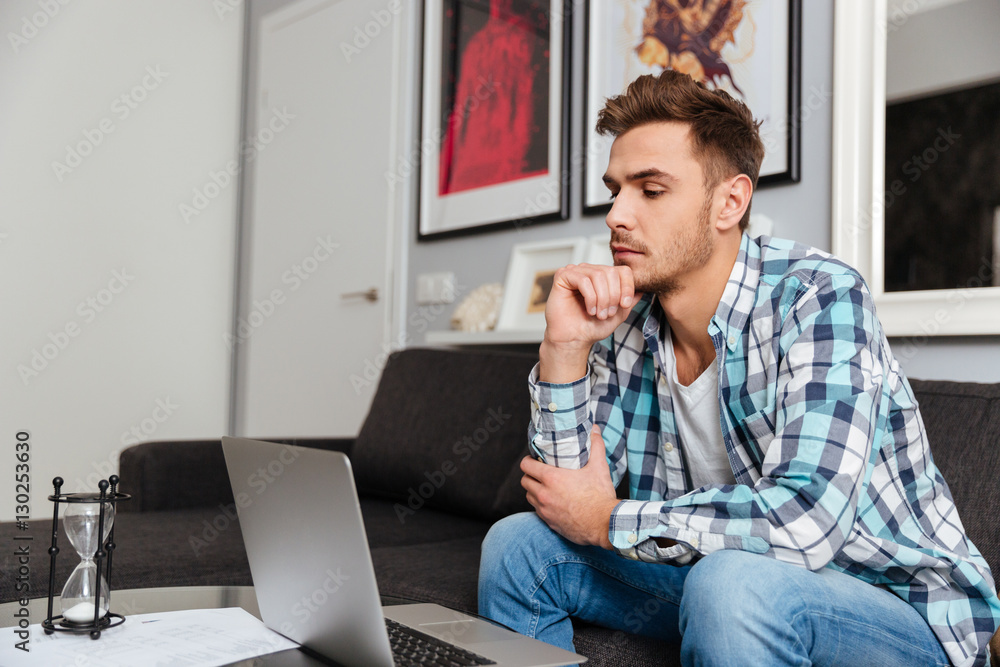 Concentrated bristle man using laptop computer. Concentrated bristle man using laptop computer.